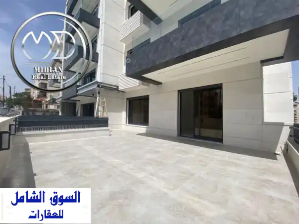 شقة أرضية جديدة للبيع في ضاحية الأمير راشد - مساحة...